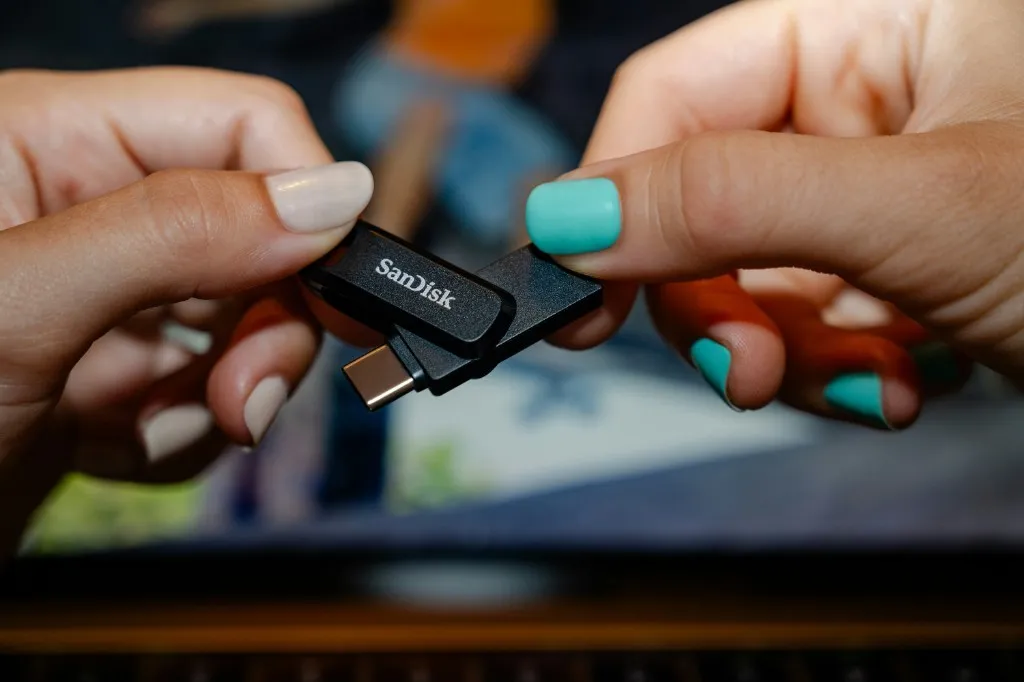 Hands holding a USB flash drive